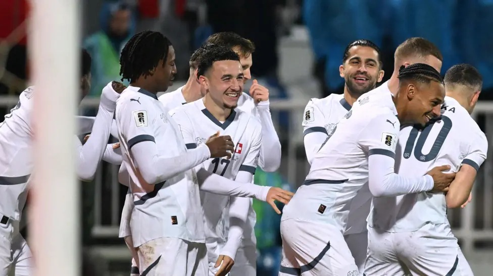 瑞士隊在2026年世界杯預(yù)選賽中保持不敗，戰(zhàn)績?yōu)樗膭賰善健? /></p>
<p>溫州網(wǎng)體育新聞，瑞士隊以不敗戰(zhàn)績鎖定2026年世界杯參賽資格，在普里什蒂納頂住了科索沃隊的最后反撲，最終與對手戰(zhàn)平。</p>
<p>上半場雙方表現(xiàn)平平，第47分鐘，魯本&middot;巴爾加斯接應(yīng)吉布里爾&middot;索烏的精準(zhǔn)傳球，從后場溜入禁區(qū)，將球送入科索沃門將阿里賈內(nèi)特&middot;穆里奇把守的球門。</p>
<p>但弗洛倫特&middot;穆斯利亞在第74分鐘以一記精彩的弧線球射門將球送入球門右上角，扳平了比分。</p>
<p>主隊在比賽尾聲階段全力爭取制勝，巴頓&middot;扎貝里賈和韋達(dá)特&middot;穆里奇的射門都被門將格雷戈爾&middot;科貝爾撲出。</p>
<p>瑞士隊需要贏球或打平才能自動獲得明年比賽的參賽資格，而科索沃隊即使贏球也可能不夠，因為瑞士隊的凈勝球優(yōu)勢非常明顯。</p>
<p>這一結(jié)果意味著瑞士隊以14分位列B組榜首，而力爭首次晉級世界杯的科索沃隊以11分位列第二，并將參加3月份的歐洲區(qū)附加賽。</p>　　本文“世預(yù)賽足球新聞”來源：http://zjjzhonglv.com/sports/7384.html，轉(zhuǎn)載必須保留網(wǎng)址。
      <div   id=